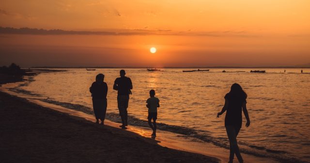 a family on the beach discussing labor day facts