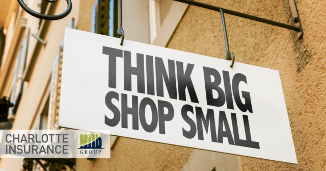 a 'thing big shop small' sign representing small business Saturday in Charlotte.