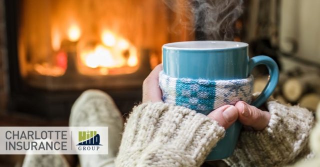 a woman enjoying her newly inspected fireplace safely while drinking a cup of coffee.