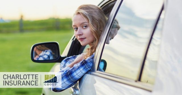 a person in a car thinking about her first auto insurance policy