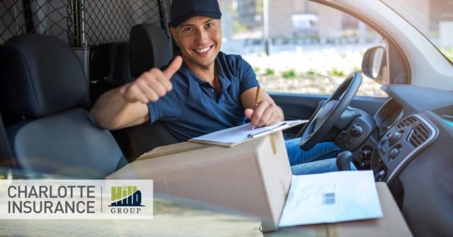 a delivery driving in their truck smiling because he knows he has the right delivery driver coverage on his auto insurance policy