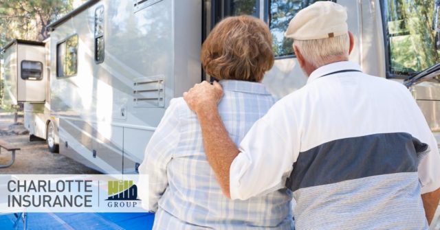 a retired couple standing in front of their RV thinking about their need for full time RV insurance