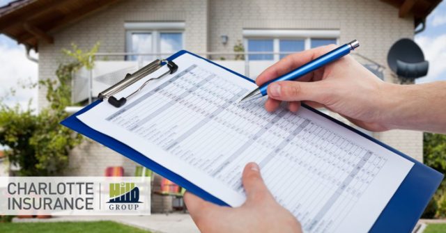 a home insurance inspector with a clipboard